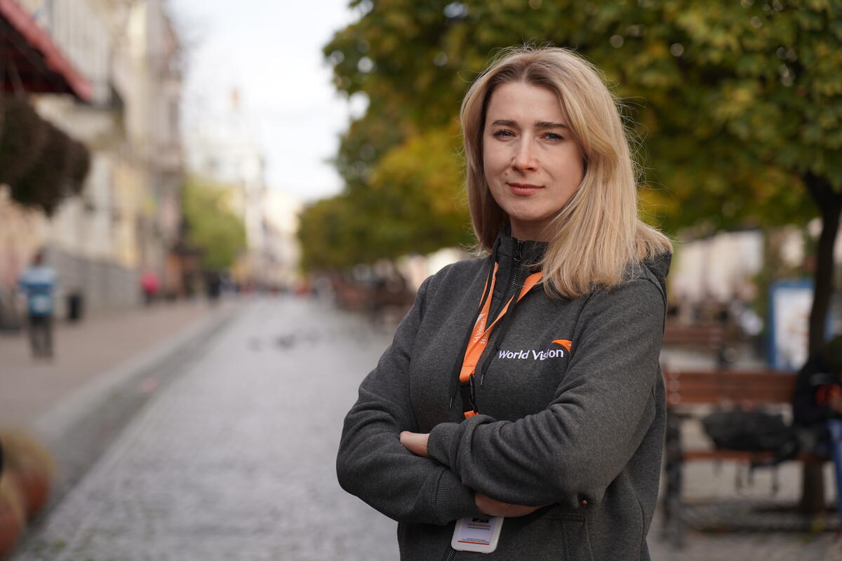 Ukrainian female World Vision staff member with arms crossed and smiling