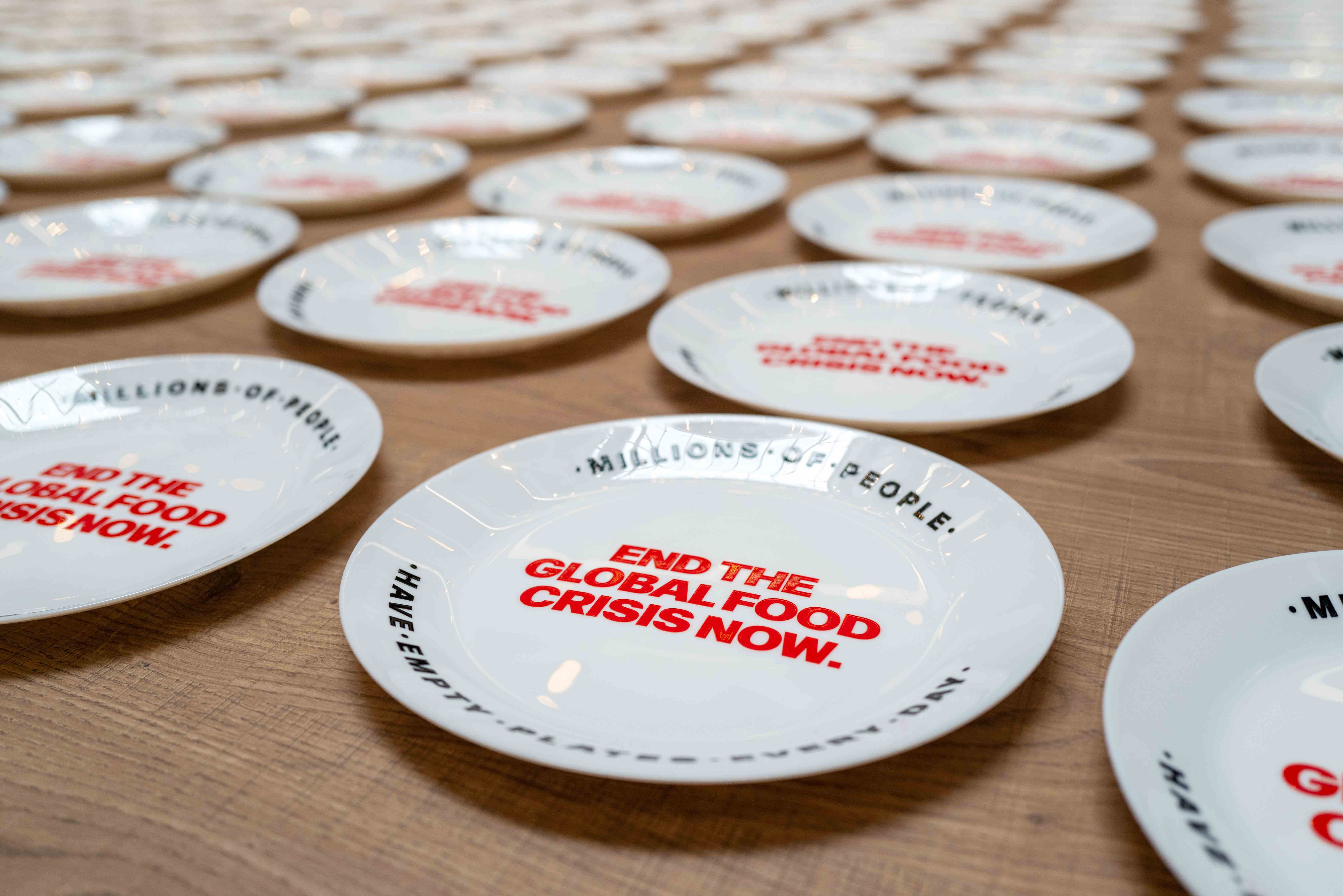 Empty plates with call to end global hunger