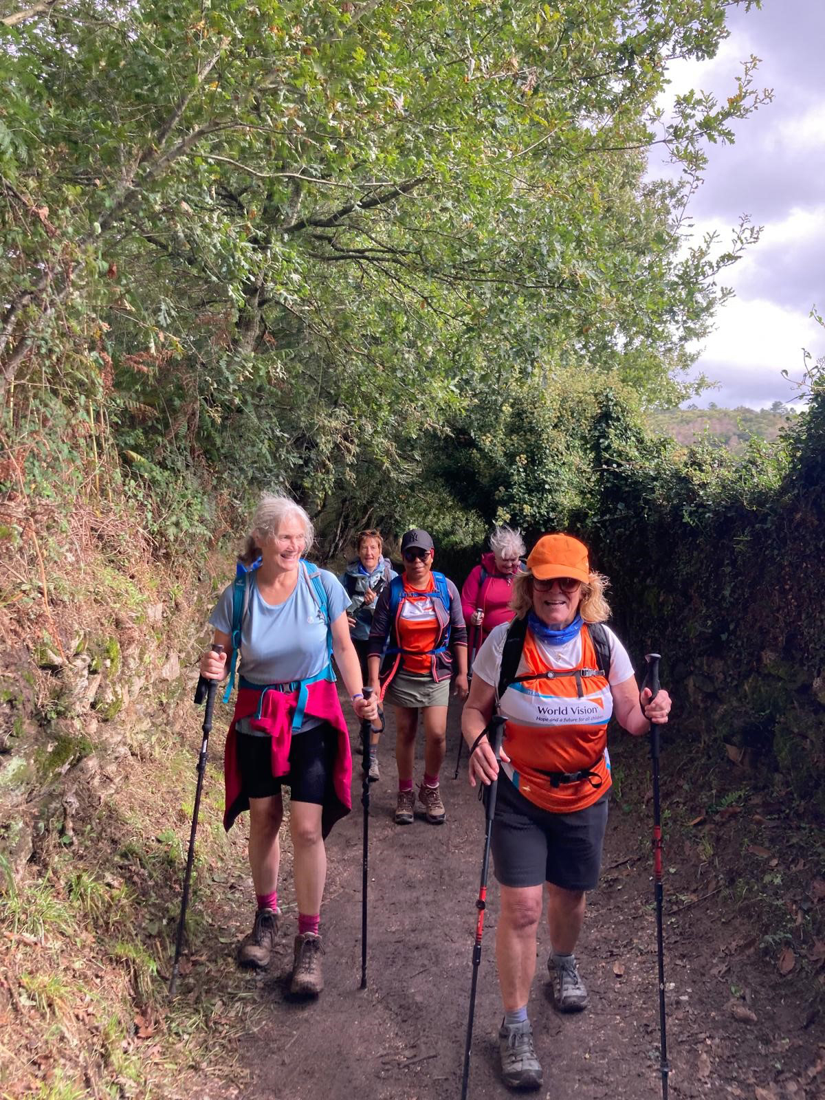 A group of World Vision supporters hike along a path on the Camino de Santiago, Spain