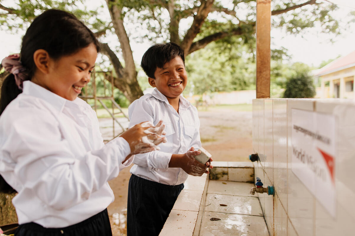 Two children washing their hands at sink