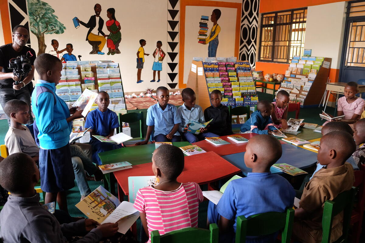 Children gathered round books on table