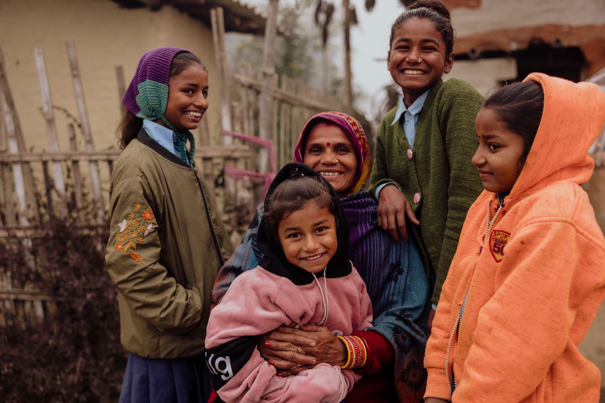 Rita, pictured with four of her daughters, is smiling because her family now has enough to eat and can continue their education