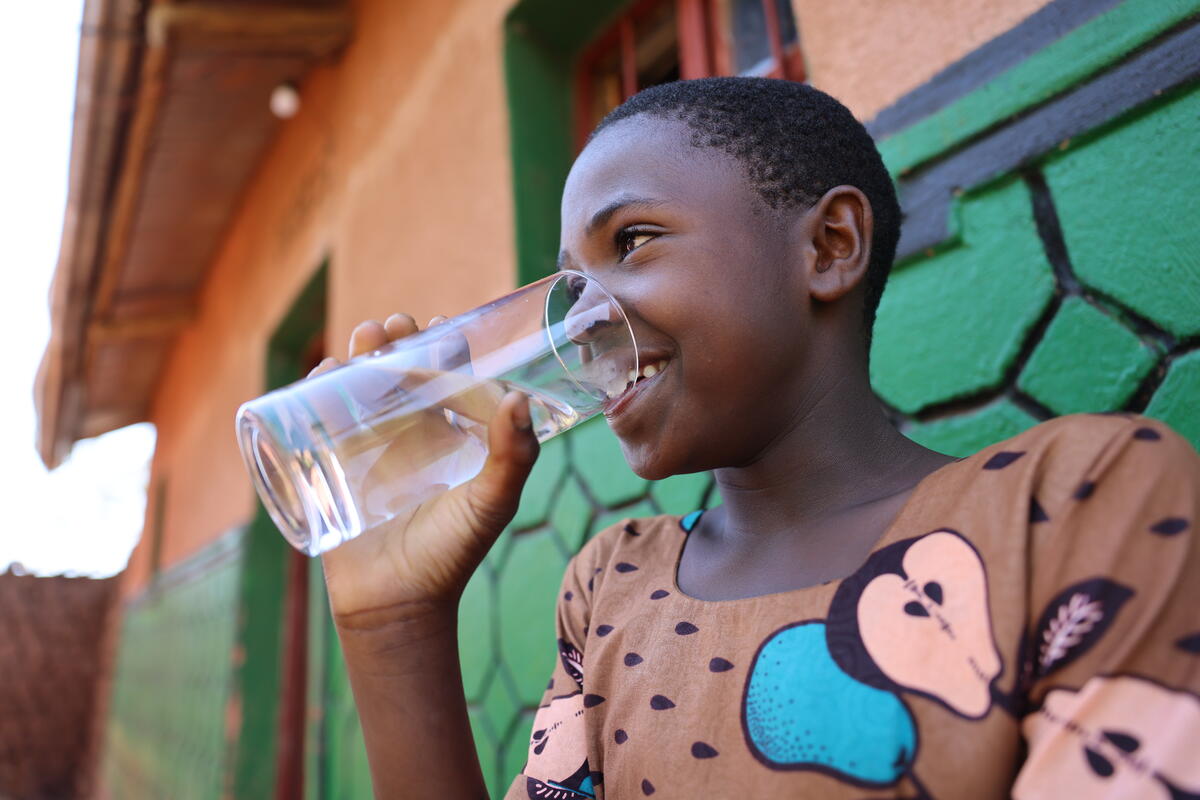 Girl from Rwanda drinking a glass of water