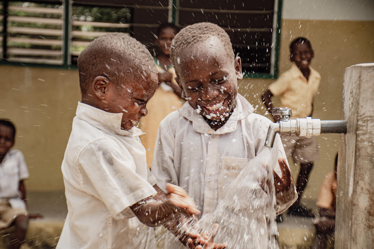 Children drinking from a tap