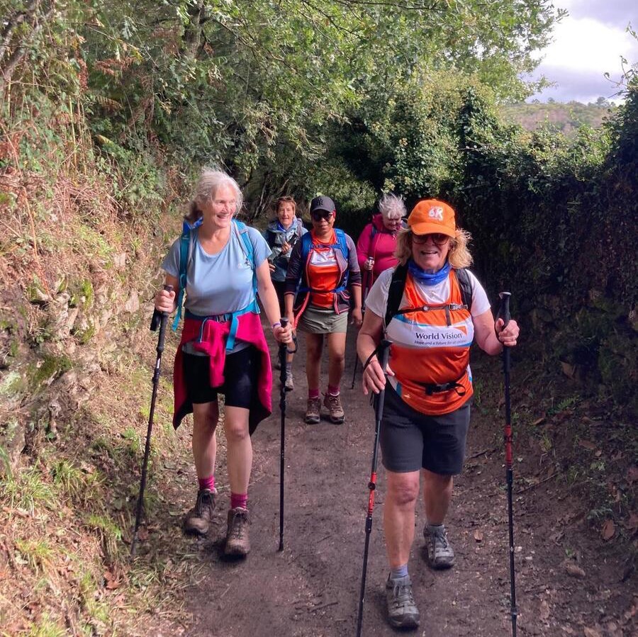 A group of World Vision supporters hike along a path on the Camino de Santiago, Spain